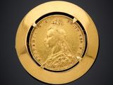 a close up of a gold coin with a crown on it