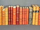 a lot of books stacked on top of each other