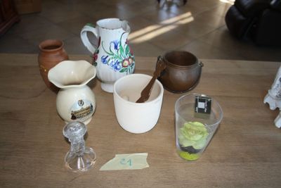 a wooden table topped with cups and bowls on it