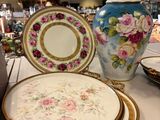 a lot of plates and vases on the table
