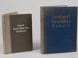 two books sitting next to each other on a white surface