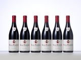 six bottles of red wine lined up in a row