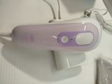 purple and white electric hair dryer sitting on top of a white table
