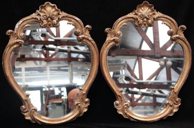 two mirrors that are sitting on a black surface