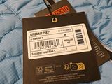 a tag on the back of a blue quilted jacket