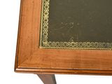 a wooden table with a black top and a gold border