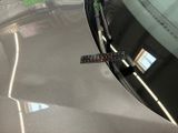 a close up of a remote control on the hood of a car