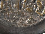 an image of a bronze plate with a scene on it