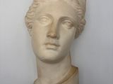 a close up of a sculpture of a woman ' s head on a wall