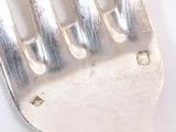 a fork that is sitting on a white table