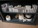 many rolls of toilet paper on a shelf in a cabinet