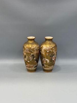 two vases are sitting on a white surface with a gray background