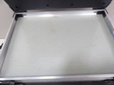 a metal box with a white sheet inside of it