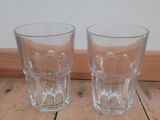 two shot glasses sitting on the floor next to each other