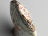 a close up of a vase on a white surface