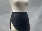 mannequin torso with black skirt on a wooden stand