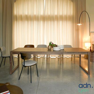 a dining room with a table and chairs in front of a large window