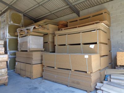 many cardboard boxes stacked on top of each other in a warehouse