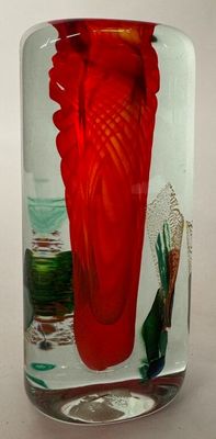a glass vase with a red flower inside of it