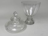 a glass jar and a glass cup sitting on a table