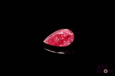 gros plan d'un diamant rose sur une surface noire