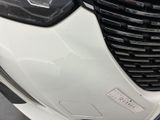 a close up of the front of a car with a number plate on it