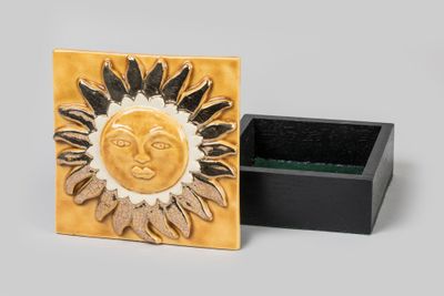 a small box that has a sun design on it