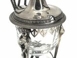 a silver plate with a spoon and spoon rest on it