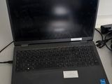 a laptop computer sitting on a desk next to a lamp