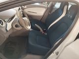 the interior of a car with blue seats and a steering wheel