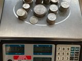 a scale with a bunch of coins on top of it
