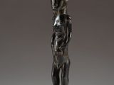 a bronze statue of a man with a hat on his head