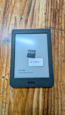 an image of a kindle sitting on top of a wooden table