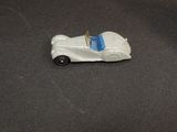 a toy car that is sitting on a black surface