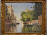 painting of a canal scene with boats and buildings in the background