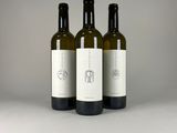 three bottles of wine sitting on top of a table next to each other