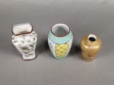 three small vases sitting next to each other on a table