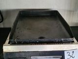 a stove top with a pan on top of it on a kitchen counter