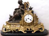 a statue of a woman sitting on top of a clock