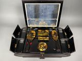 a black case with gold and silver items inside of it