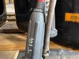 a vacuum that is on the floor next to a bucket