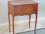 a small wooden table with a drawer on top of it