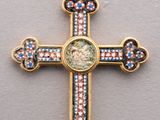 a close up of a cross with a face on it