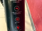 a close up of a bike with a red wall
