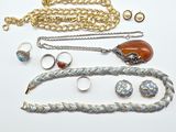 a lot of jewelry that is laying out on the table
