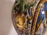 a vase that has a dragon on it on a table