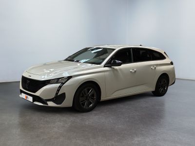 the white car is parked in a large room with a gray floor