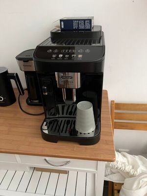a small coffee maker on a small table in a room