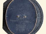 a black plate with a metal handle on it