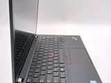 a black laptop with a red button on the keyboard